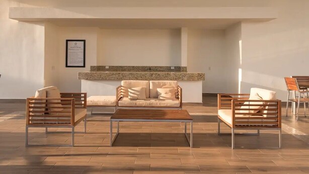A modern living room with a sofa, two armchairs, a coffee table, and a fireplace. - CASA ROBLE by TRVL2HM (Nuevo Nayarit)
