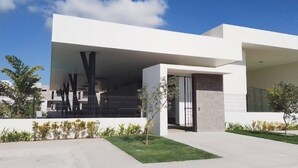 A modern building with a flat roof, large overhang, and a covered entrance area. - CASA VELA by TRVL2HM (Nuevo Nayarit)