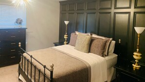 A bedroom with a bed, nightstands, a dresser, and a globe on the dresser. - Near Nashville Medical District (NASHVILLE)
