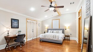 A bedroom with a bed, desk, chair, and a ceiling fan. - "Life of Riley" 3bd/3ba Irish Channel Home! (New Orleans)