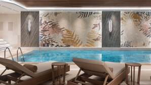A modern indoor pool area with lounge chairs and a large wall mural. - Burdock Hotel Istanbul, Autograph Collection (Istanbul)