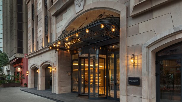 A building with a revolving door entrance, a sign for 'BURDOCK', and a plaque for 'AUTOGRAPH COLLECTION'. - Burdock Hotel Istanbul, Autograph Collection (Istanbul)