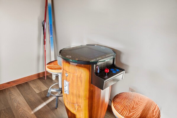 A wooden arcade machine with a glass top and joystick controls.