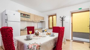 A dining area with a table set for breakfast, including croissants and orange juice. - Gorgeous home in Susak with WiFi (Susak)