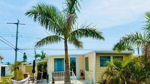 A single-story house with a front porch, a hammock, and a palm tree. - Cozy retreat, near some of the best Florida beaches! (Bradenton)