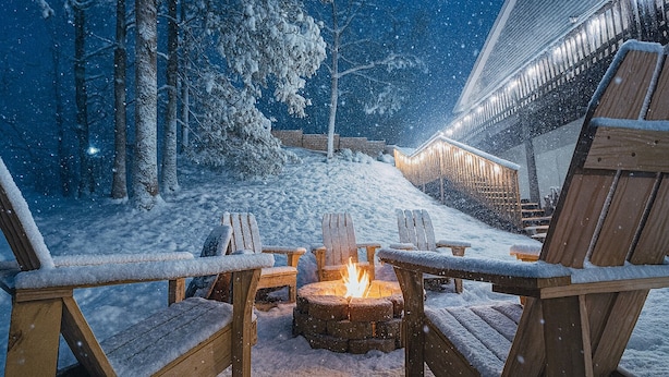 A snow-covered outdoor seating area with wooden chairs and a fire pit. - The Ravine • Hot Tub Forest Escape, Epic Gameroom, Fast WIFI & Pet Friendly (Basye)