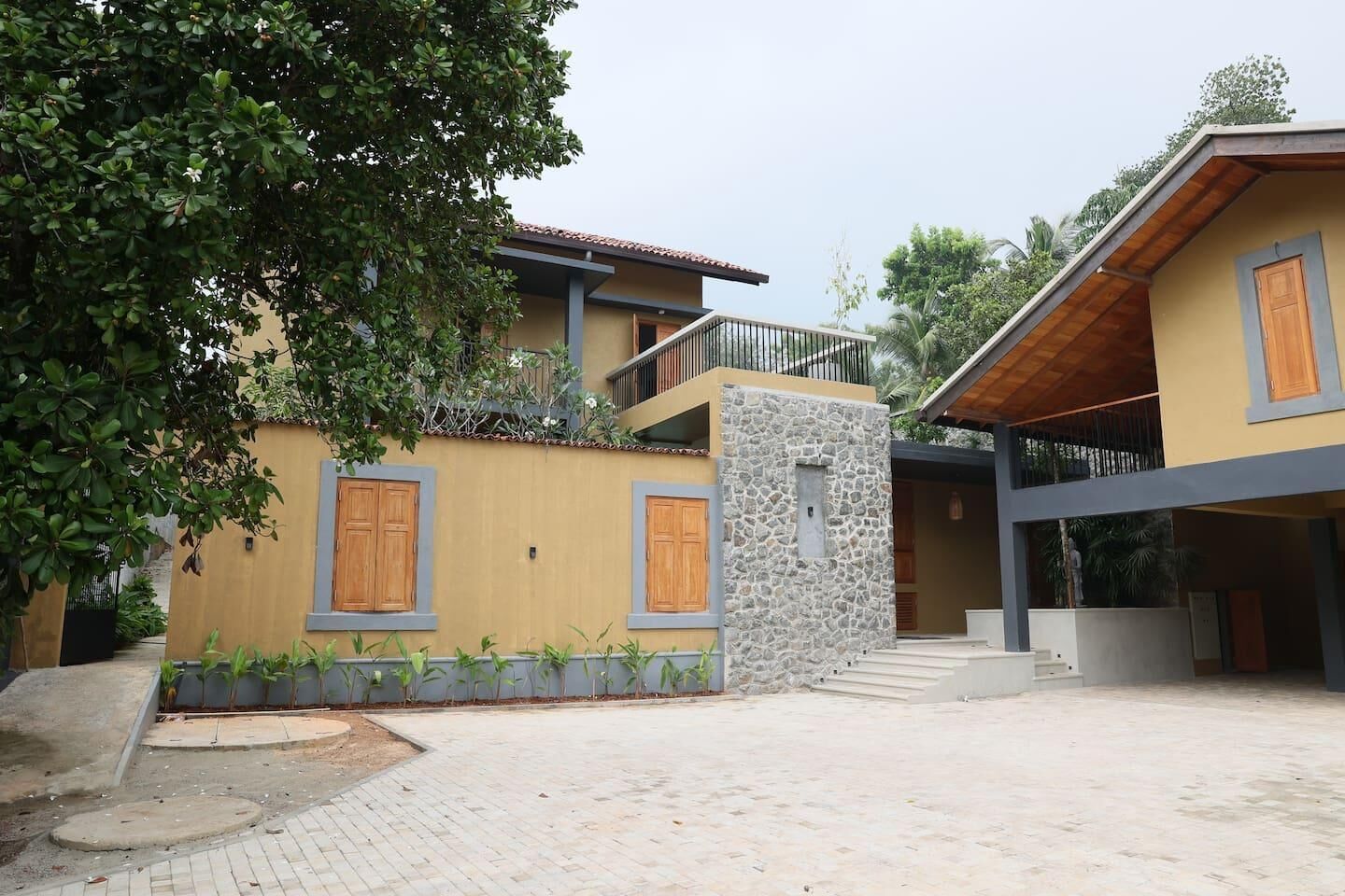 A two-story building with a stone facade and wooden doors.