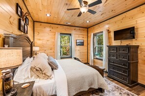 Cozy bedroom with a bed, dresser, and television, offering a comfortable space to rest and unwind.