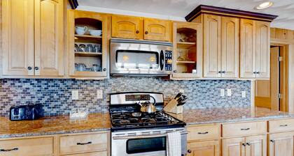 Lakefront, dog-friendly home with dock, kayaks, SUPs, canoe, huge deck & firepit