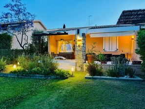 A house with a covered patio, stone pillar, and potted plants. - VILLA MIRTO IS PART OF THE MOLAS RESORT (Pula)