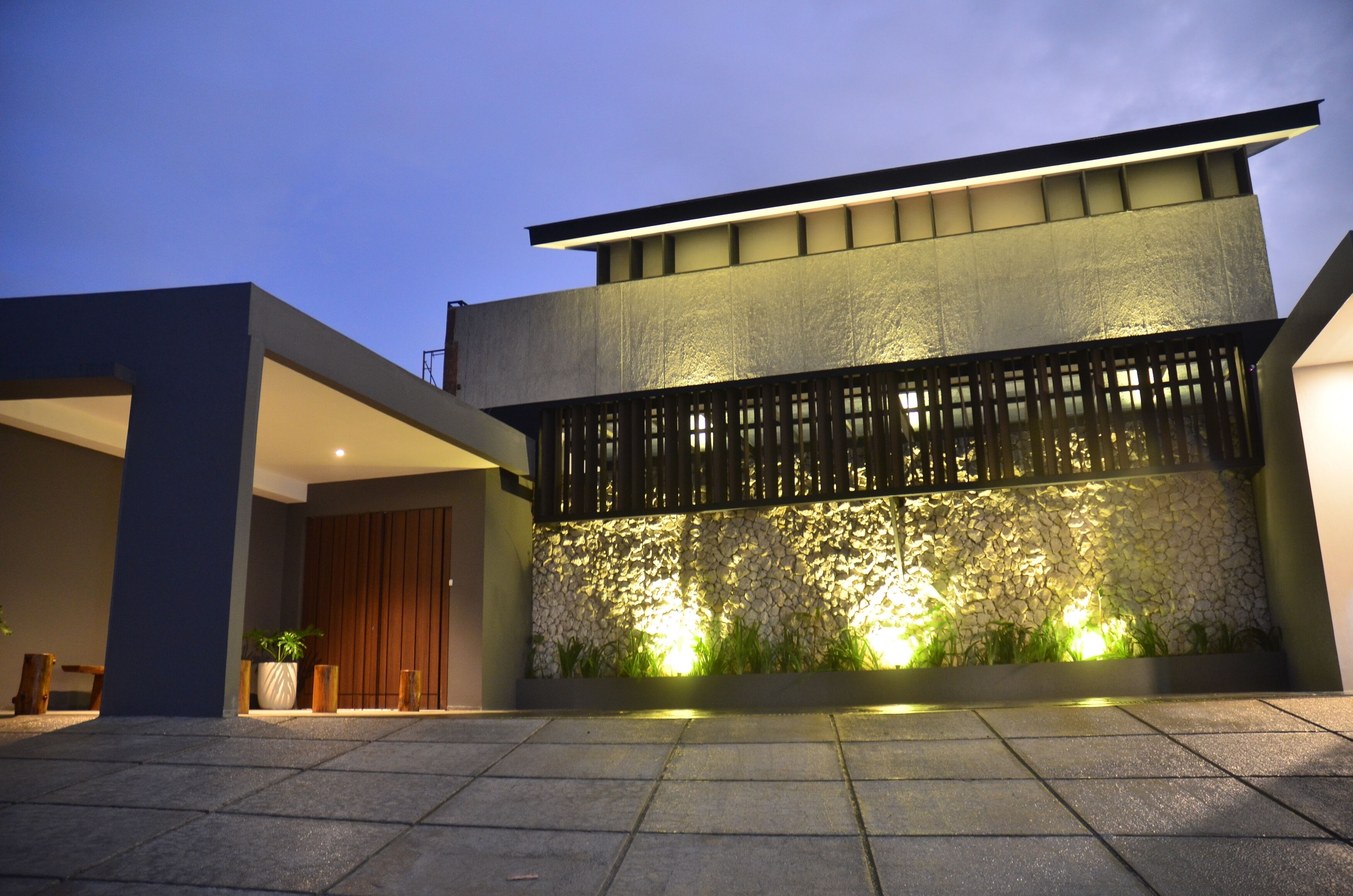 A modern building with a stone facade and a flat roof.