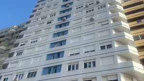 A multi-story building with balconies, large windows, and air conditioning units. - Studio with terrace and spectacular views (La Línea de la Concepción)