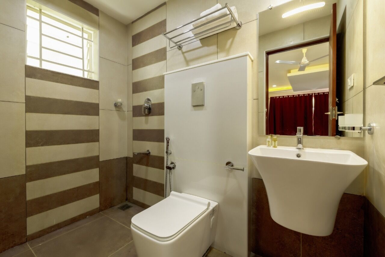 A bathroom with a shower, toilet, and sink.