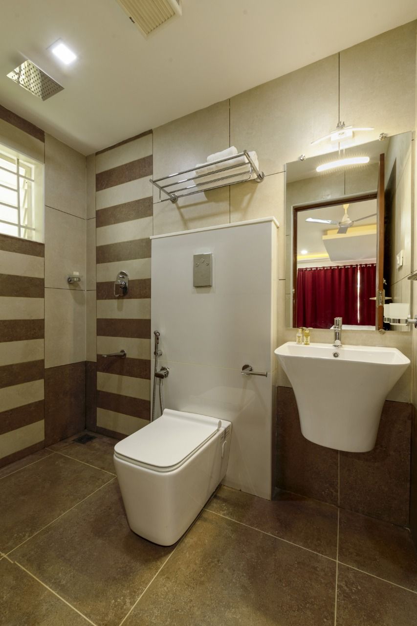 A bathroom with a shower, toilet, and sink.