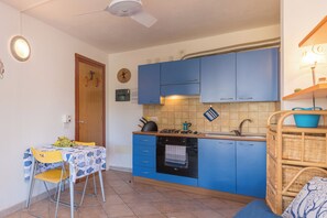 Family Apartment, 1 Bedroom (Casa Emozione With Shared Pool) | Private kitchenette | Oven, stovetop, cookware/dishes/utensils, dining tables