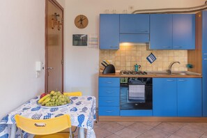 Family Apartment, 1 Bedroom (Casa Emozione With Shared Pool) | Private kitchenette | Oven, stovetop, cookware/dishes/utensils, dining tables