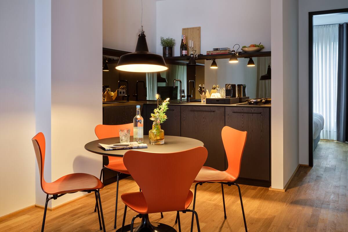 A modern kitchen with a dining area.
