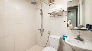 A bathroom with a shower, toilet, and sink. - Sonata Central Hotel & Spa (Hanoi)