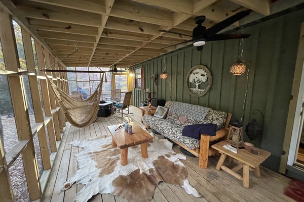 Screened in side porch with access to back deck and master bedroom.