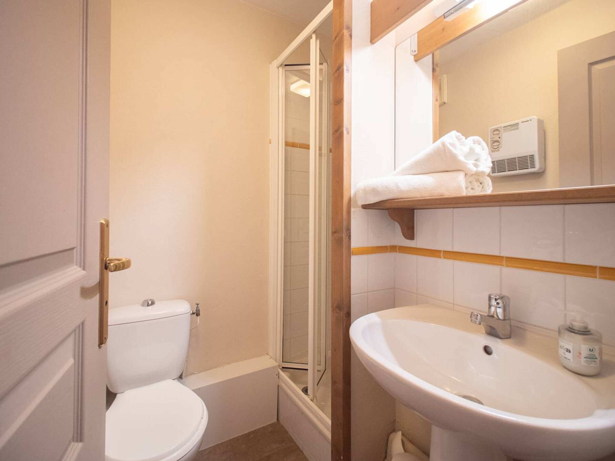 A bathroom with a toilet, a sink, and a shower.
