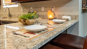 A kitchen with granite countertops, a built-in stove, and a small island with a candle. - Luxurious AC Home Near Heart of Downtown, NAU, Snowbowl, Historic Route 66 (Flagstaff)