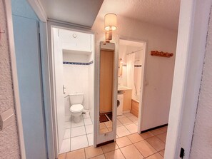 A bathroom with a toilet, sink, and shower. - Cozy Apartment Near Slopes with Balconies (Montvalezan-La Rosière)