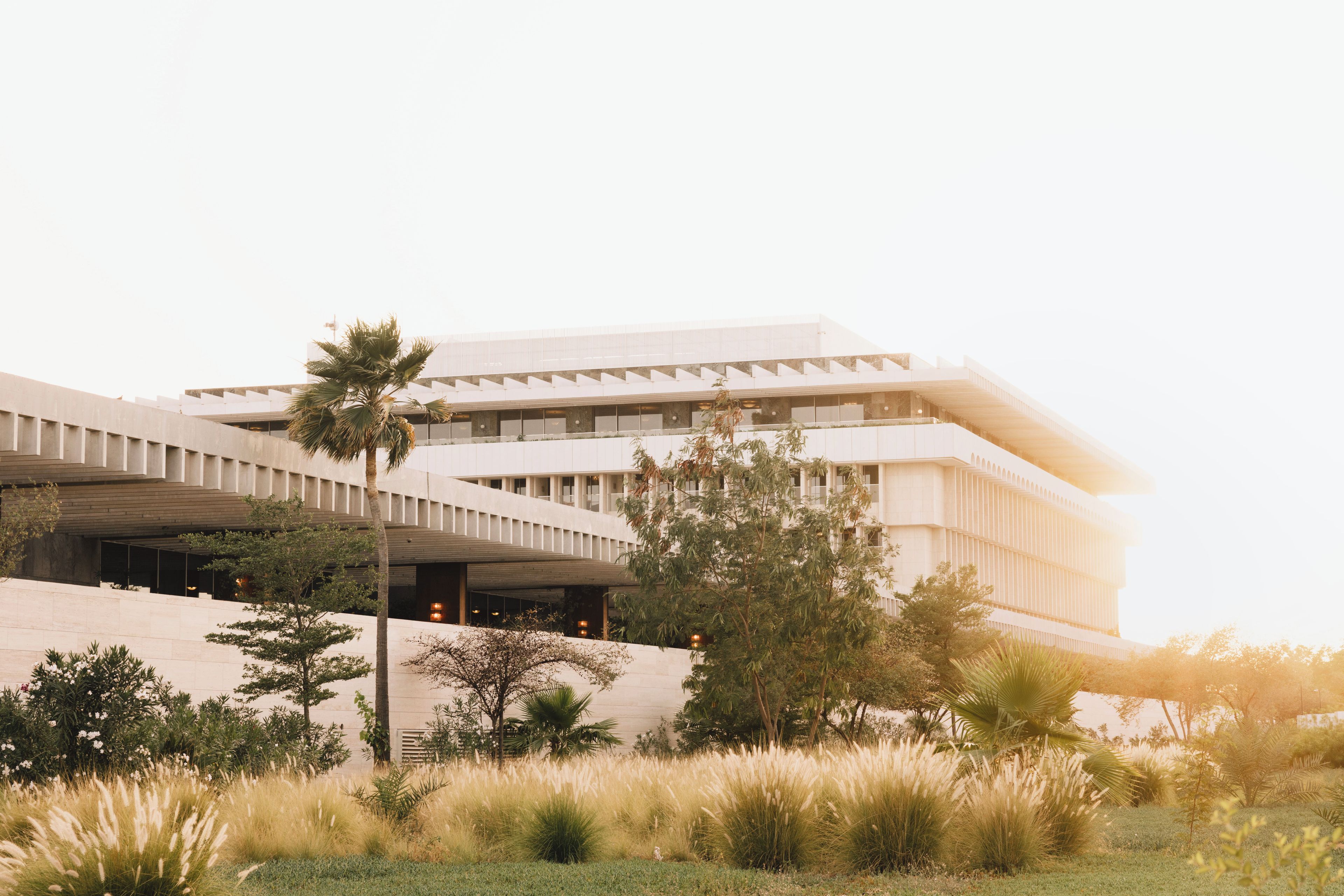 A modern building with a flat roof and a sloped side facade.