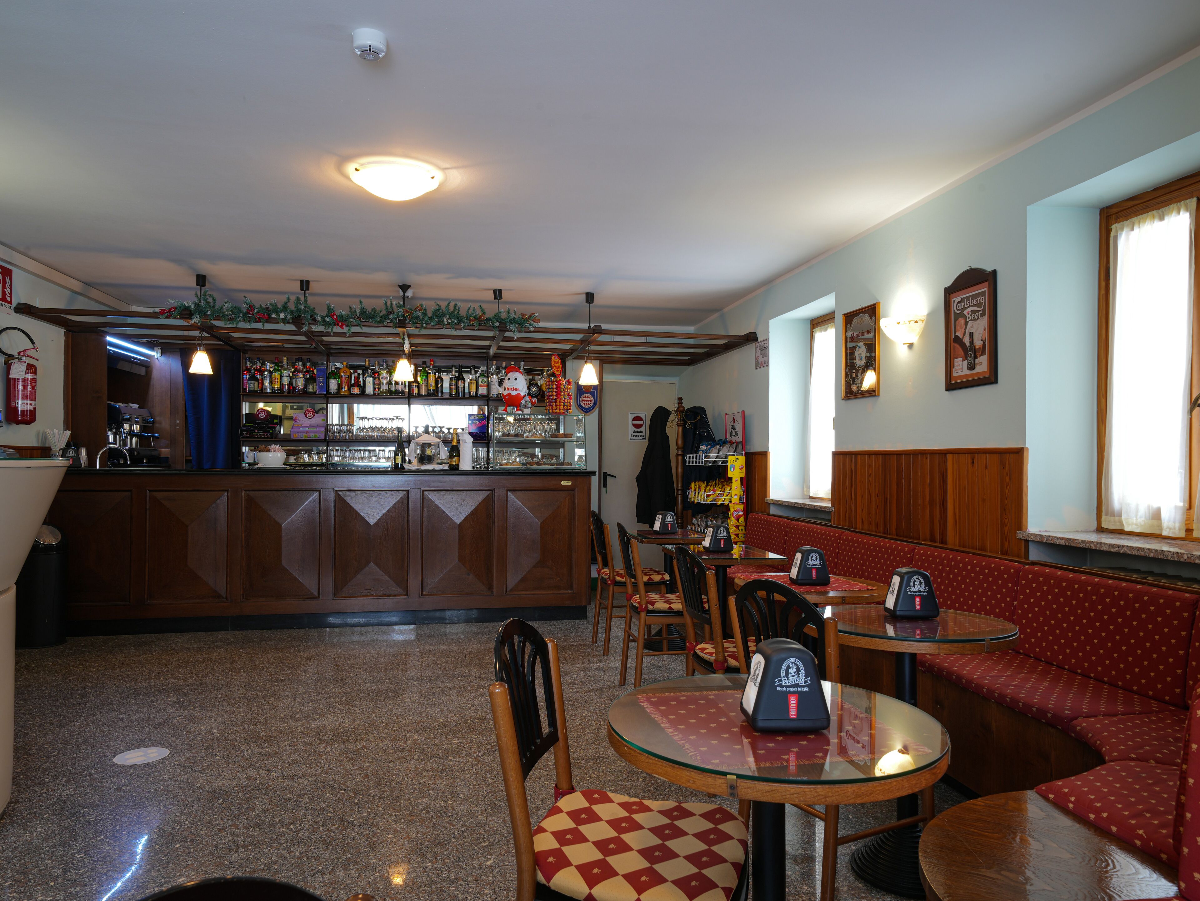 A bar area with a counter, seating, and a visible fire extinguisher.