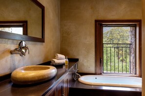 A bathroom with a wooden sink, a mirror, and a window with a view of greenery. - Domaine du Reginu (Feliceto)
