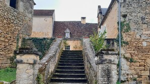 A stone staircase leading to a building with a tiled roof.