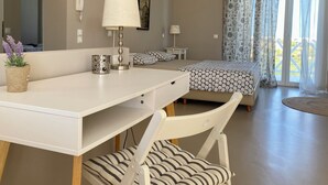 A modern bedroom with a bed, bedside tables, a desk, and a chair. - Romantic Villa with Private Pool & Whirlpool (Πύργος)
