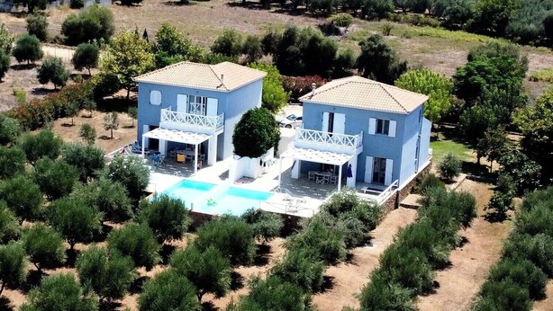 A two-story house with a swimming pool, surrounded by trees and vegetation. - Romantic Villa with Private Pool & Whirlpool (Πύργος)