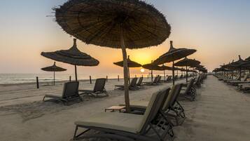 Private beach, white sand, sun loungers, beach umbrellas