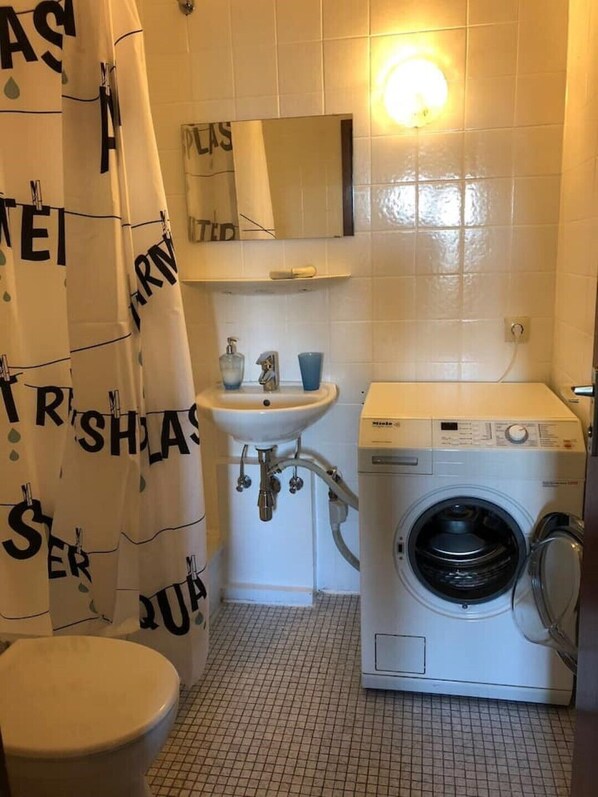 Shower, hair dryer, slippers, towels