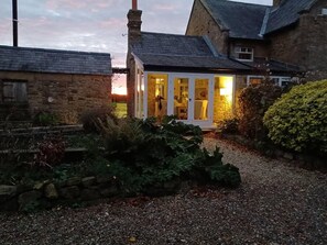 A stone house with a gravel driveway leading to a glass door entrance. - 3 Bed Cottage-sleeps 6-country Views-pet Friendly (Sunderland)