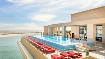 Outdoor pool, open 6:00 AM to 9:00 PM, pool umbrellas