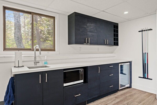 A modern kitchen with a built-in microwave, a sink, and a dishwasher.