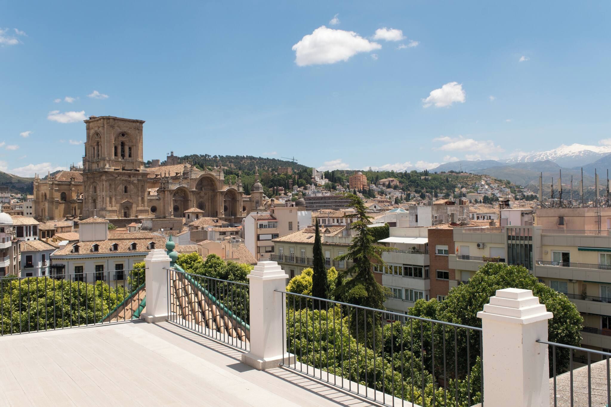 A cityscape with a prominent historical building, modern residential buildings, and a clear sky.