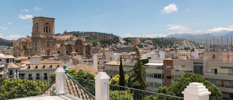 A cityscape with a prominent historical building, modern residential buildings, and a clear sky.