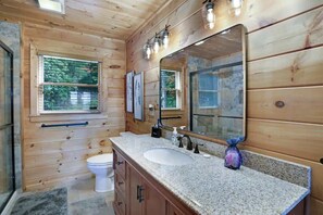 Bathtub, hair dryer, towels, shampoo