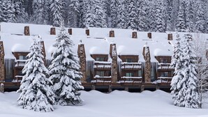 A snow-covered lodge with multiple balconies and a stone facade. - Silver Vista End Unit | Pool & Ski Shuttle, Hot Tub, Fireplace, Balcony (Durango)