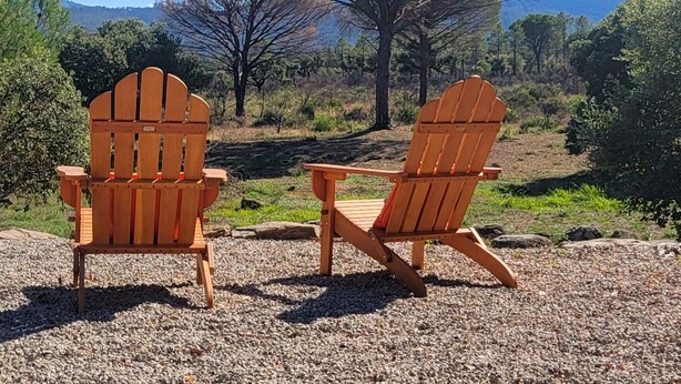 Two Adirondack chairs facing each other with a mountainous landscape in the background. - le Mas du Rouquan (Vidauban)