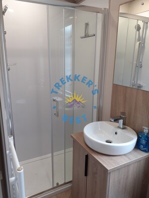 Shower, hair dryer, towels, toilet paper