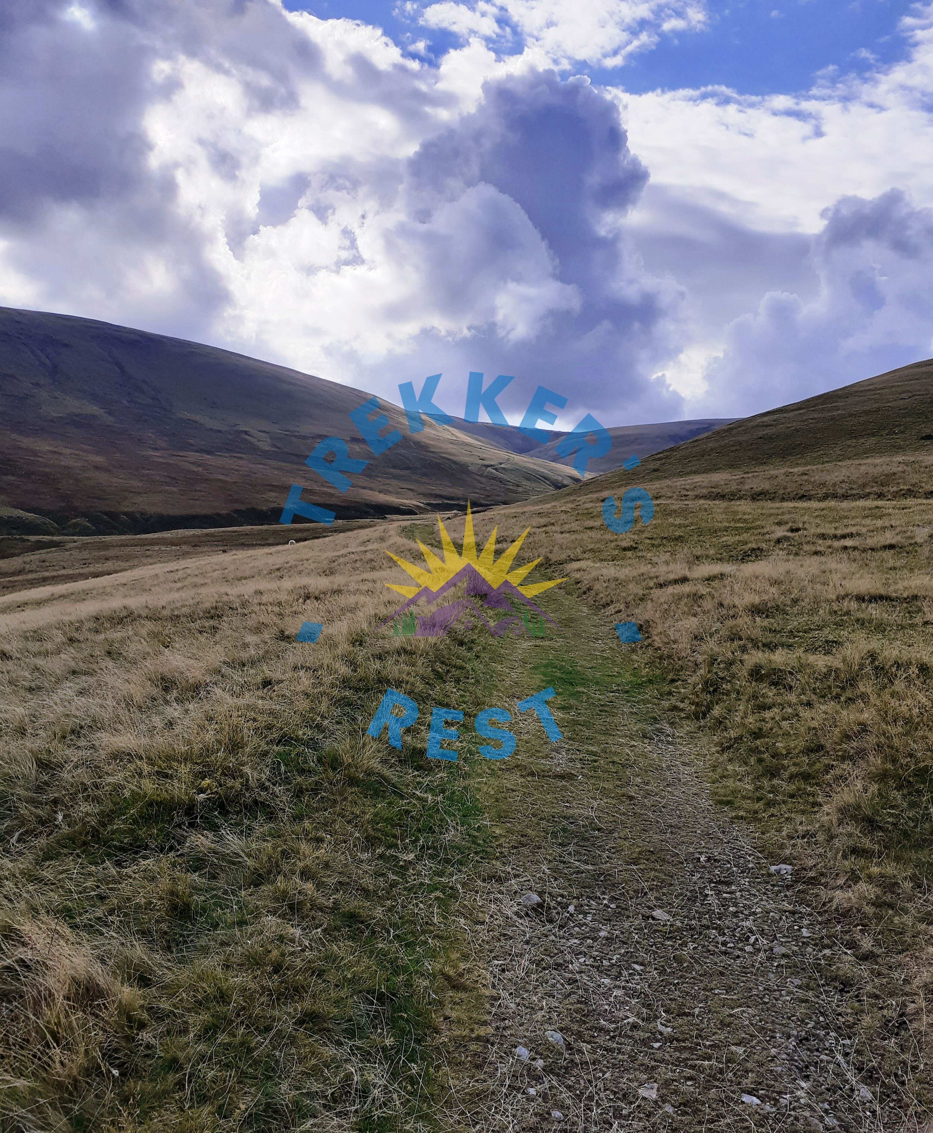 A hilly landscape with a path leading through it.