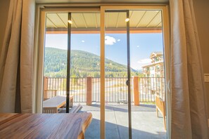 Relax on the balcony with a view of the surrounding mountains and parking area.