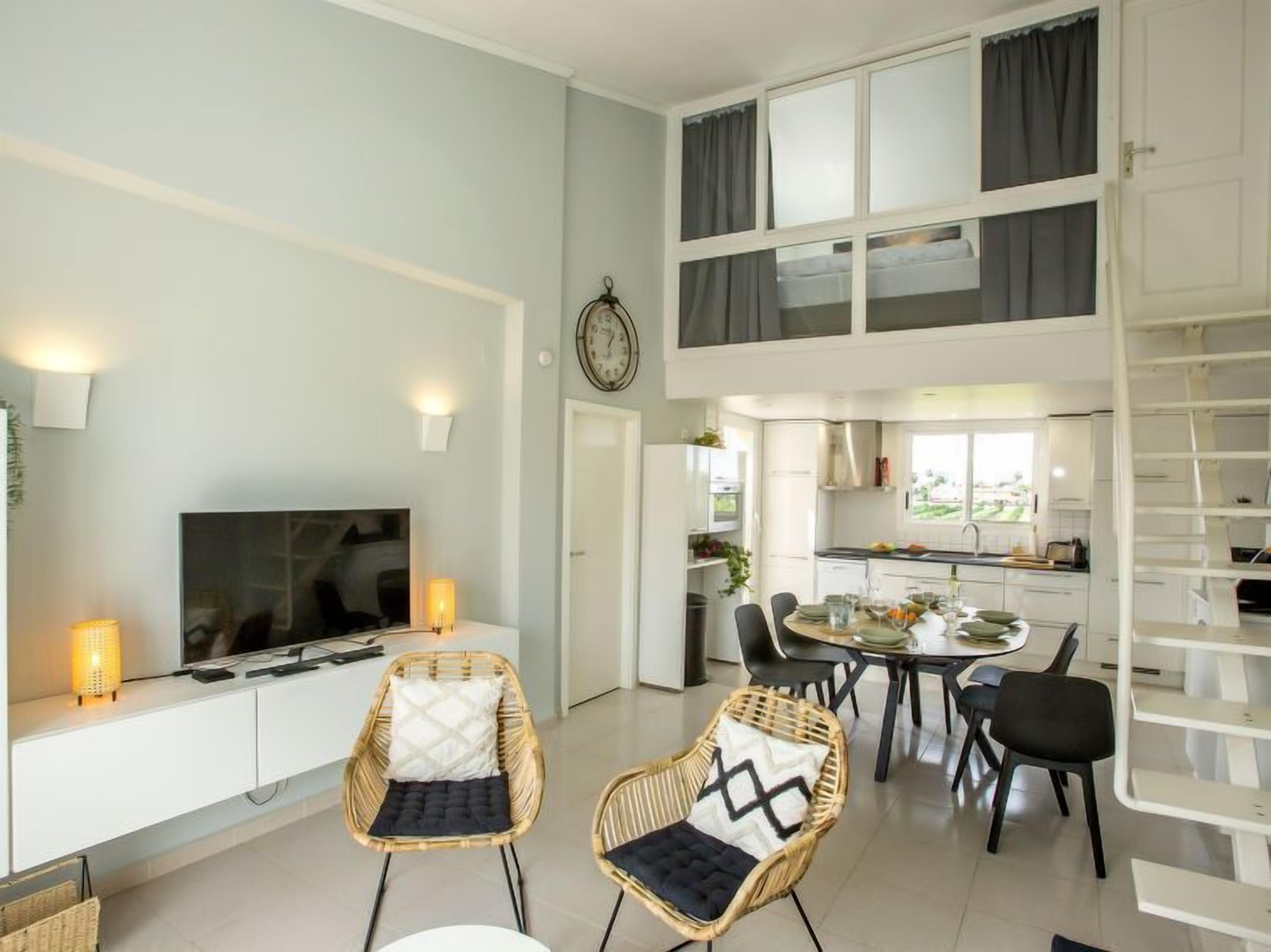 Ein modernes Apartment mit Essbereich, Küche und Wohnbereich.