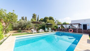 A rectangular swimming pool with clear blue water, surrounded by a wooden deck and a white fence. - Holiday Home "Cortijo Indalo" with Pool & Wi-Fi (Pechina)