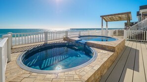 A pool area with two hot tubs and a pergola overlooking a beach. - Big Blue -Mini-Resort, Movie Theater, Pools, Hot Tub, Beach Front, Sleeps 28! (Surf City)