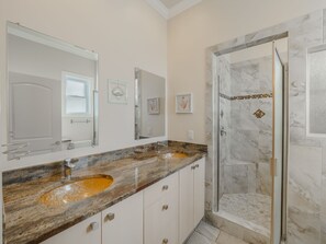 A bathroom with two sinks, a shower, and a large mirror. - Big Blue -Mini-Resort, Movie Theater, Pools, Hot Tub, Beach Front, Sleeps 28! (Surf City)