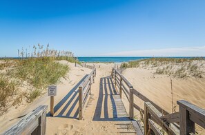 A wooden boardwalk leading to a beach with a sign that reads "Please keep off dunes." - Prissy Gale - S Nags Head MP 17.5, 60 Yds to Beach, Fire Pit, Pets OK, Pier Passes (South Nags Head)